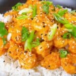 Air Fryer Bang Bang Shrimp feature image close up with garnish over jasmine rice