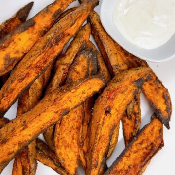 air fryer sweet potato fries close up with garlic aioli feature image