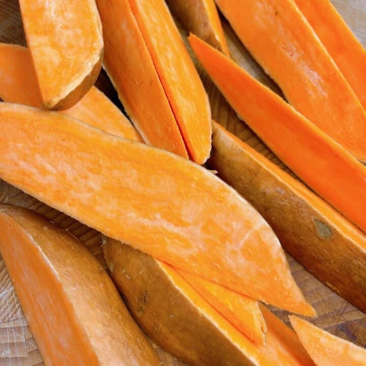 air fryer sweet potato wedges being cut into wedges