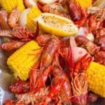 boiled crawfish feature image close up in foil container