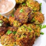 Broccoli patties feature image close up with dipping sauce and garnish