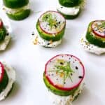 healthy cucumber bites with cream cheese radish and dill feature image. 7 stack with white background.