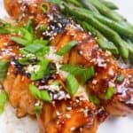 Korean bbq salmon feature image with garnish on top over rice with a side of green beans.