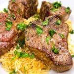 Pan seared lamb loin chops feature image over a bed of rice
