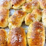 Pepperoni rolls feature image close up on sheet tray with parmesan and seasoning