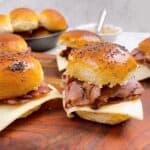 Roast beef sliders feature image 6 sliders prepared with buns and mustard in background.