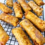 Vegetarian egg rolls recipe feature image close up of 10 egg rolls on wire rack