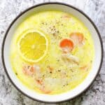 Avgolemono Soup Instant Pot Recipe: Greek Lemon Chicken and Orzo feature image close up bowl of soup with lemon