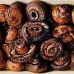 Burgundy mushrooms resting in sauce.