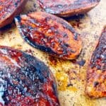 Crispy caramelized sweet potatoes on a sheet pan.