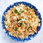 coleslaw recipe for pulled pork feature image coleslaw in blue serving bowl