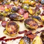 crispy brussels sprouts with bacon and balsamic easy oven roasted recipe feature image close up on sheet pan with balsamic drizzle