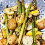 easy grilled summer squash asparagus and potatoes feature image. bbq side dish on stainless steel grill pan seasoned.