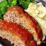 How to make a southern meatloaf feature image close up on a plate sliced with mashed potatoes and broccoli