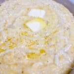 Instant pot grits with manchego cheese feature image close up of cheesy grits with pats of butter