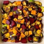 oven roasted fall vegetables feature image sweet potatoes beets and Brussels cooked in casserole dish