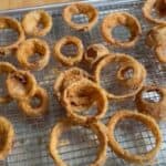Southern style onion rings with buttermilk feature image close up fried on wire rack