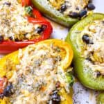 cheesy baked tex mex stuffed peppers feature image close up of four peppers stuffed with toppings
