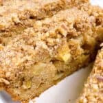Apple loaf cake with cinnamon crumb topping sliced on platter feature