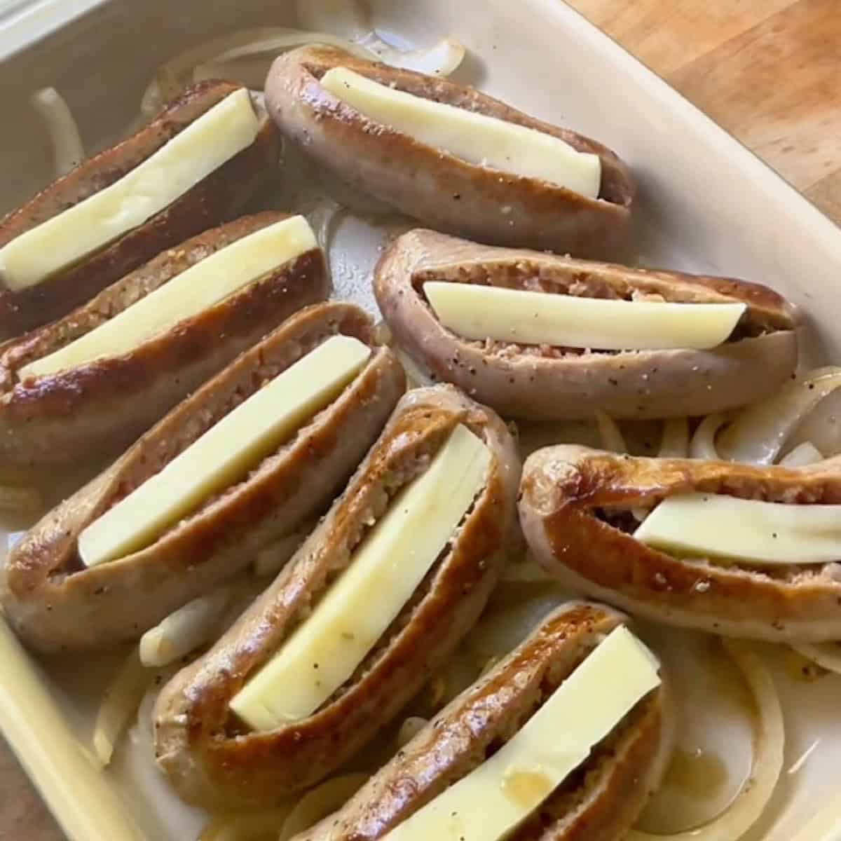 Browned sausages stuffed with mozzarella over a bed of onions.