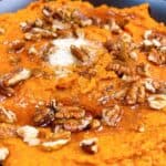 Creamy mashed sweet potatoes with brown sugar and cinnamon feature image close up with toppings