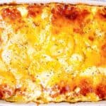 Creamy three cheese scalloped potatoes feature image close up in casserole dish