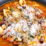 Beef and Bean Pasta Soup Pasta e Fagioli Recipe feature image close up in black bowl with toppings.
