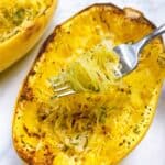 Air fryer spaghetti squash recipe with parmesan and garlic feature image close up with strands on fork.