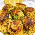 Greek chicken meatballs with lemon spinach orzo feature image close up in white bowl.