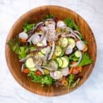Simple Italian Salad Recipe spring mix with fresh vegetables process shot 2 adding veggies.