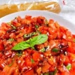 Bruschetta Dip with Creamy Boursin Cheese hero image close up in bowl with baguette.