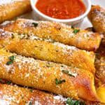 Easy pizza egg rolls air fryer feature image close up with toppings and marinara for dipping.