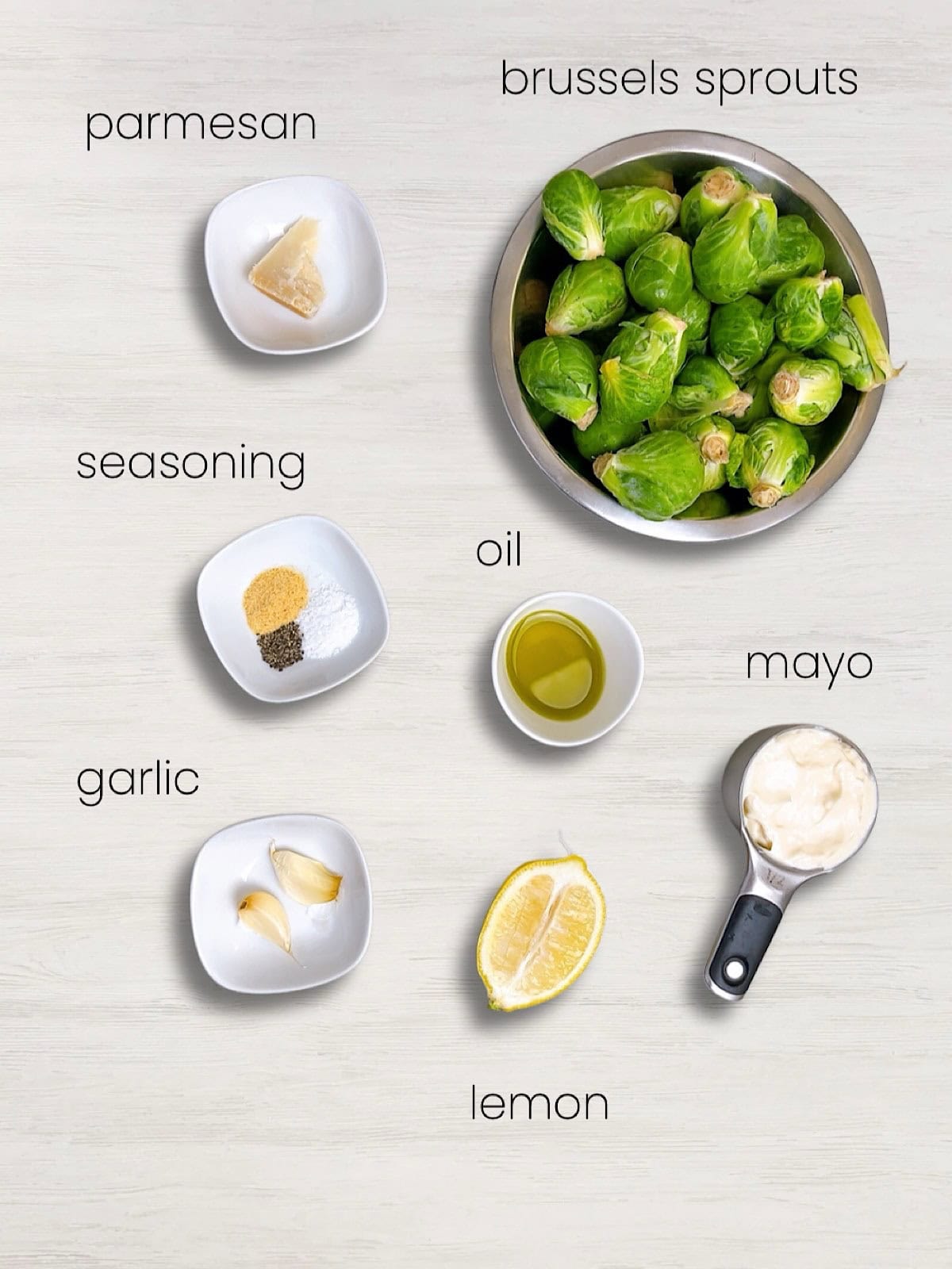 A labeled ingredient photo of everything needed to make crispy air fryer brussels sprouts.