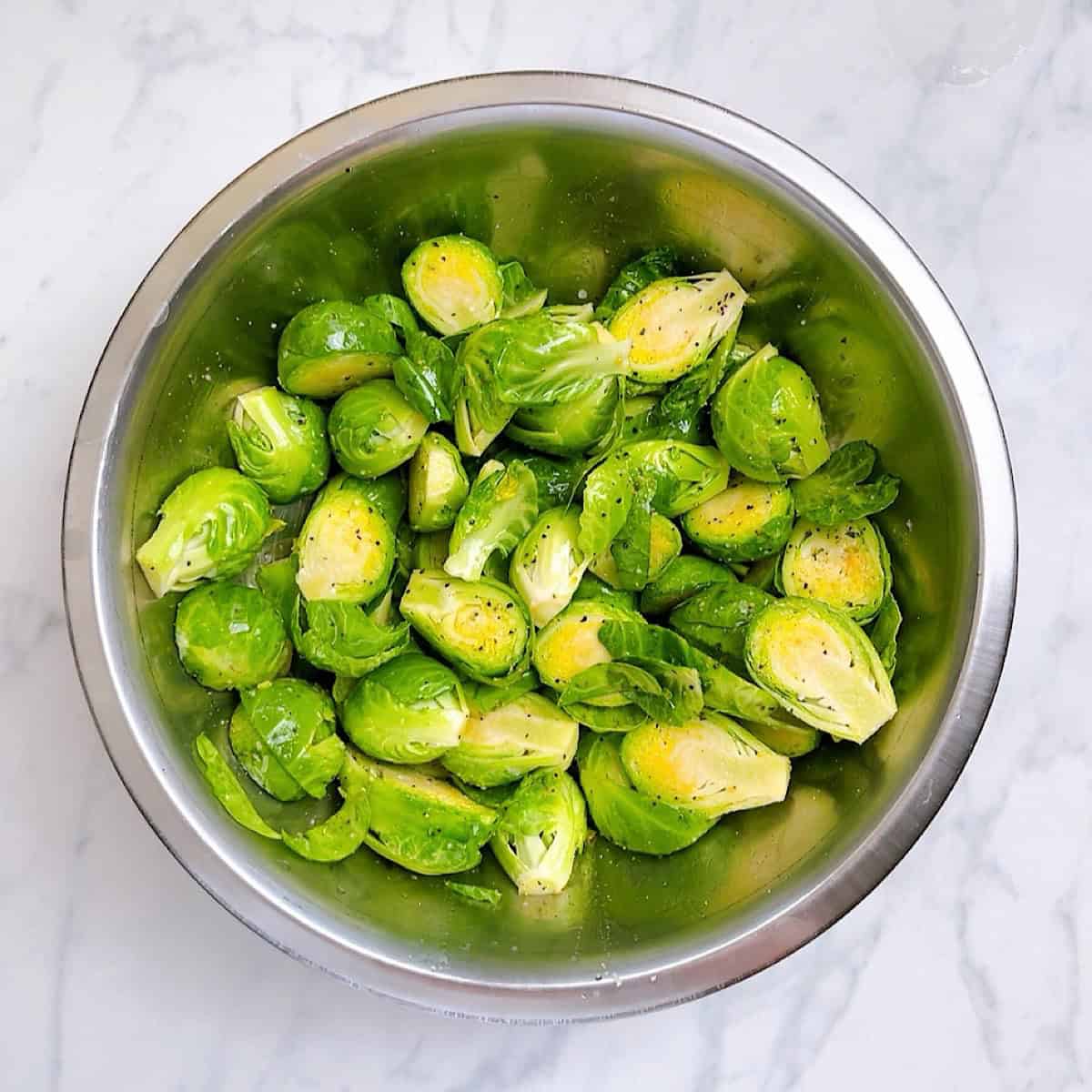 Brussels in a mixing bowl coated with oil and seasoning.