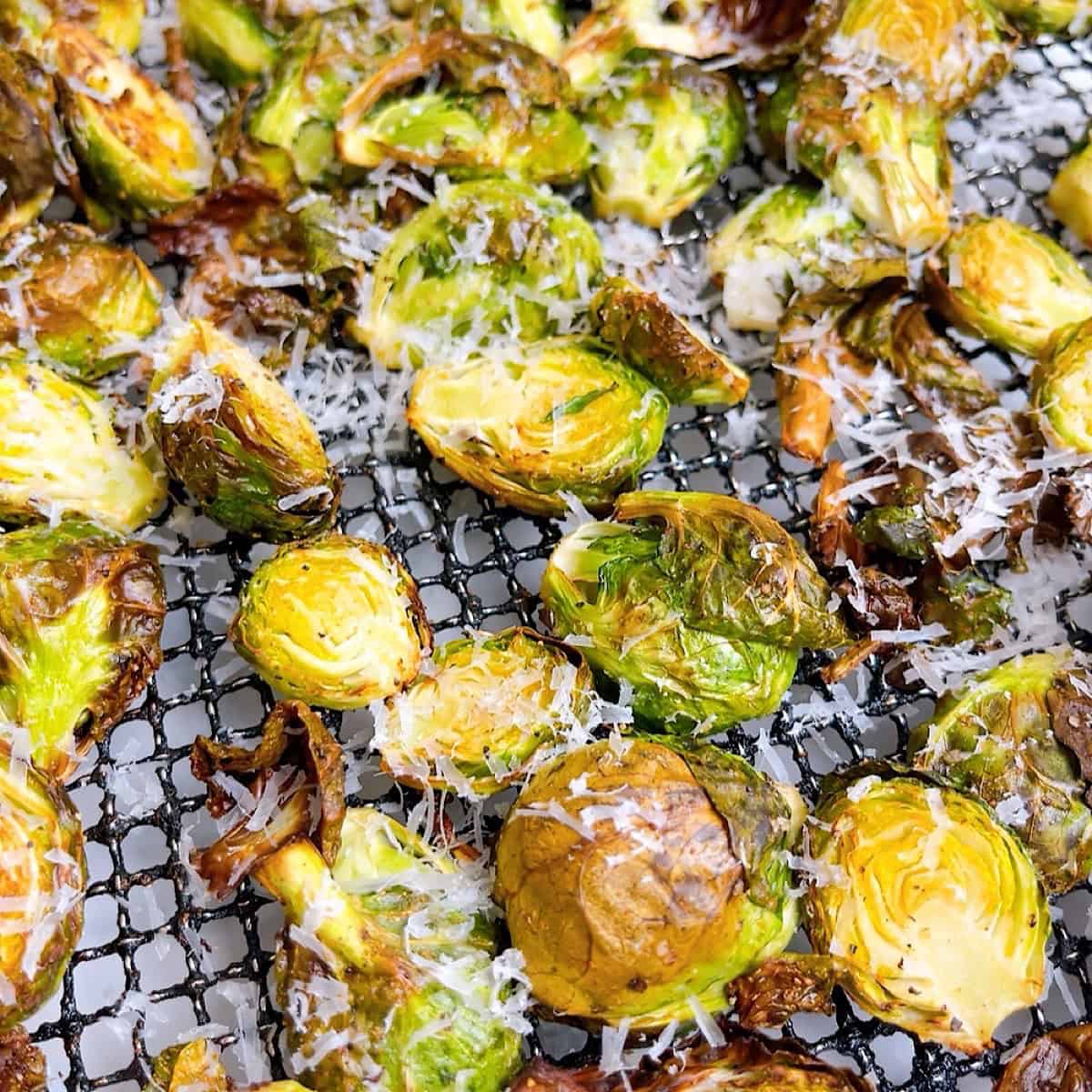 Crispy cooked brussels with shredded parmesan cheese on top.