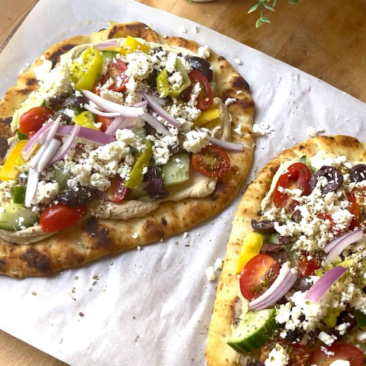 Mediterranean pizza with toppings added.