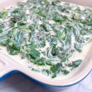 An image of steakhouse spinach in a small blue casserole dish.
