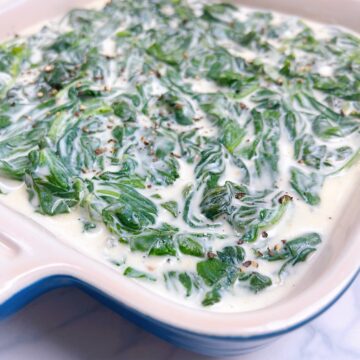 An image of steakhouse spinach in a small blue casserole dish.