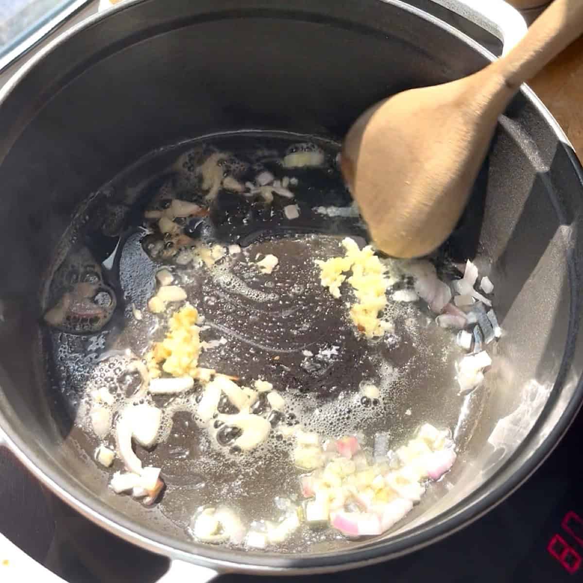 Sauteeing shallot with garlic and butter in dutch oven.