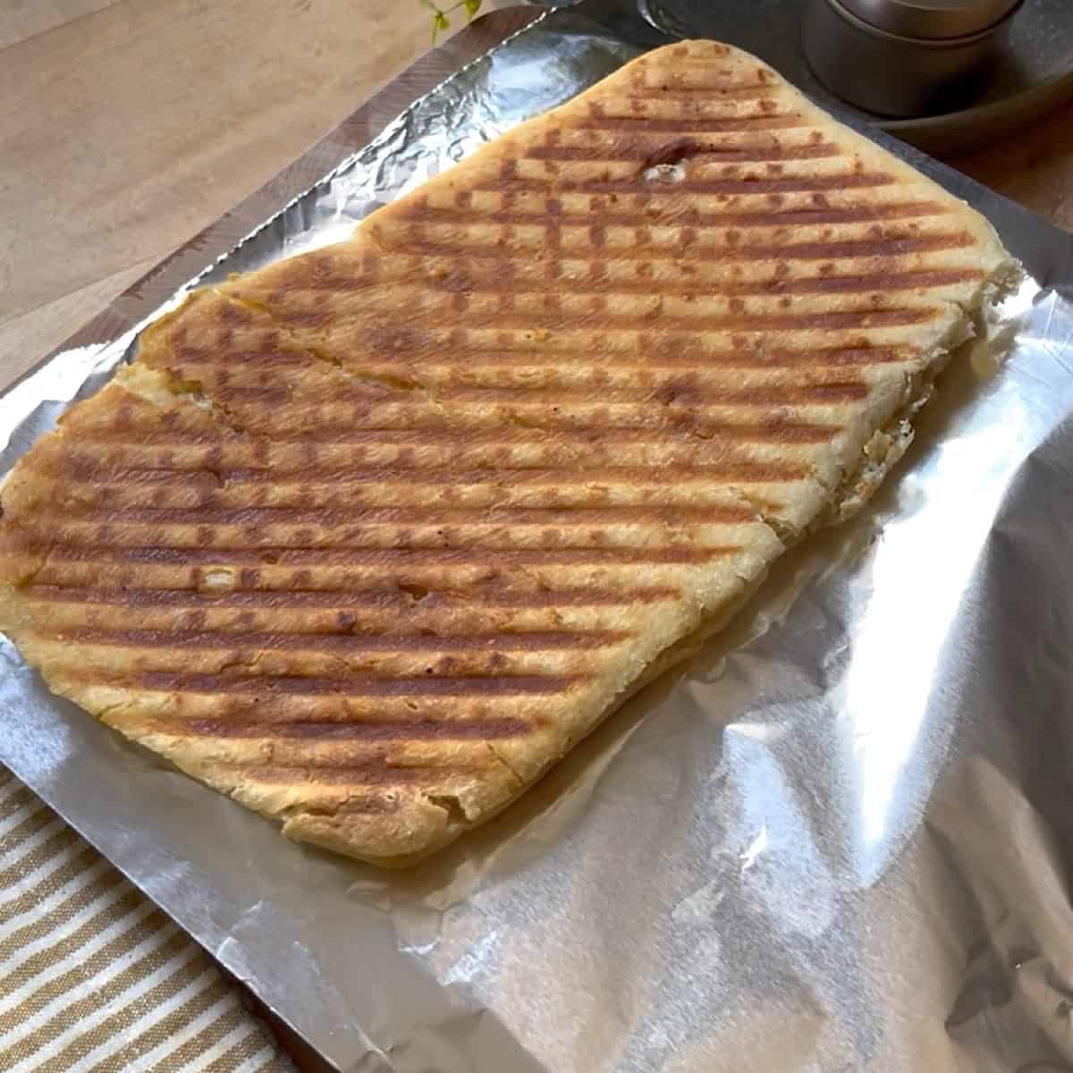Ciabatta bread pressed with char lines diagonal.