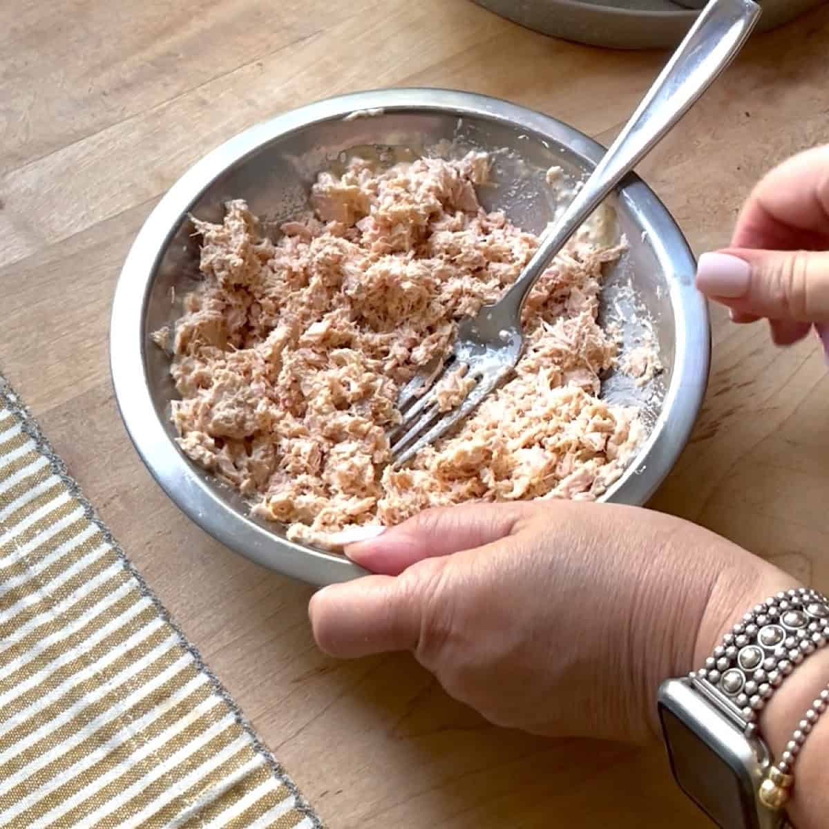 Tuna mousse being mixed in a bowl.