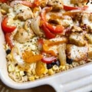 Cheesy chicken fajita bake with oregano sprinkled over top in a casserole dish.