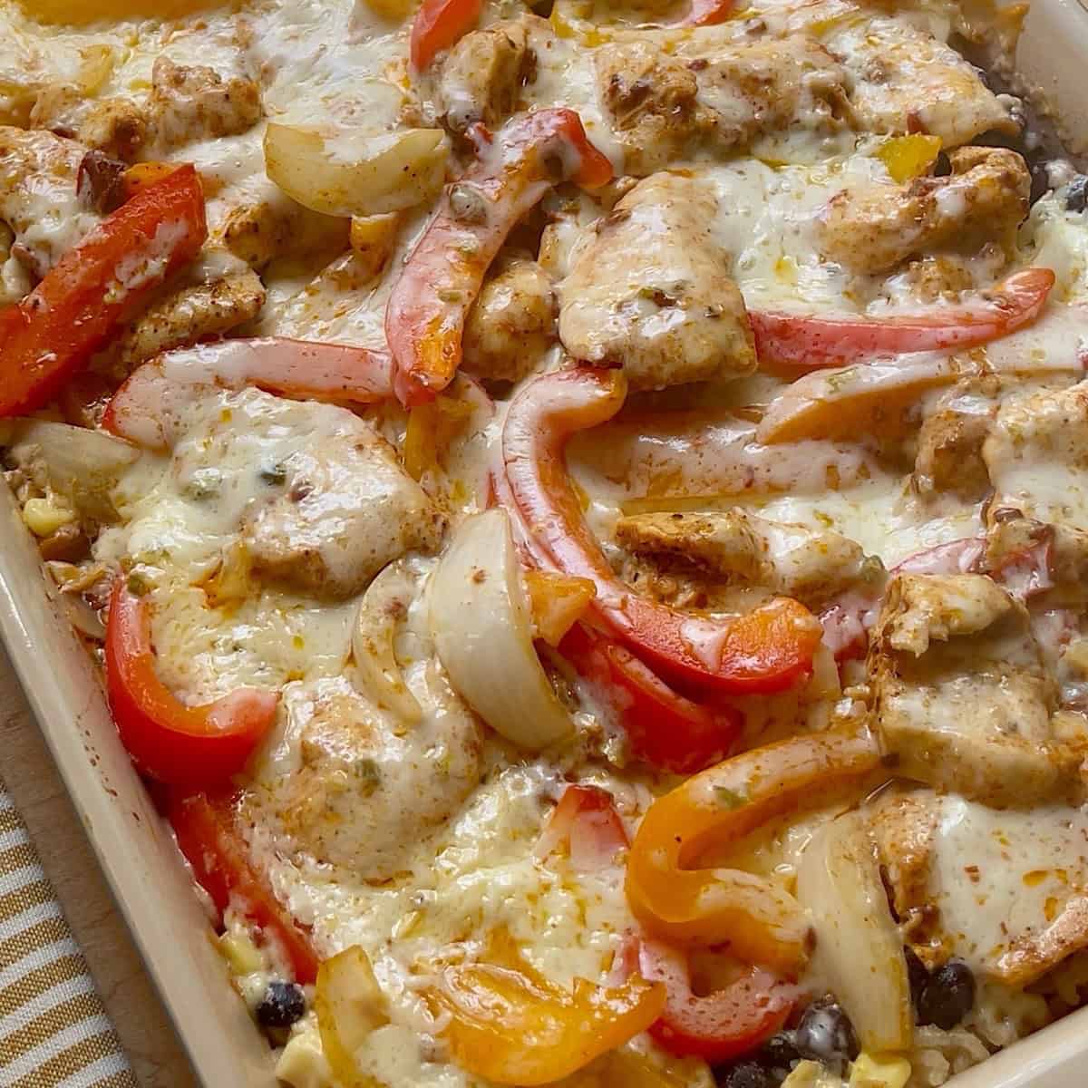 Chicken fajita bake removed from the oven with melted cheese on top.