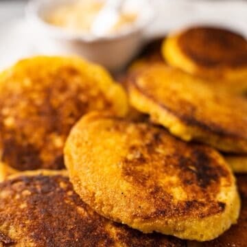 Hoecakes on an elegant platter with a side of honey butter.