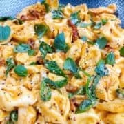 Marry me tortellini prepared in pan with garnish.
