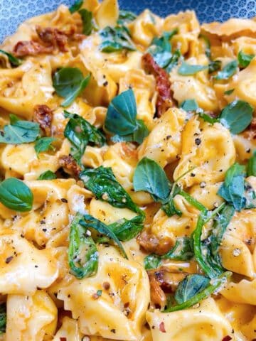 Marry me tortellini prepared in pan with garnish.