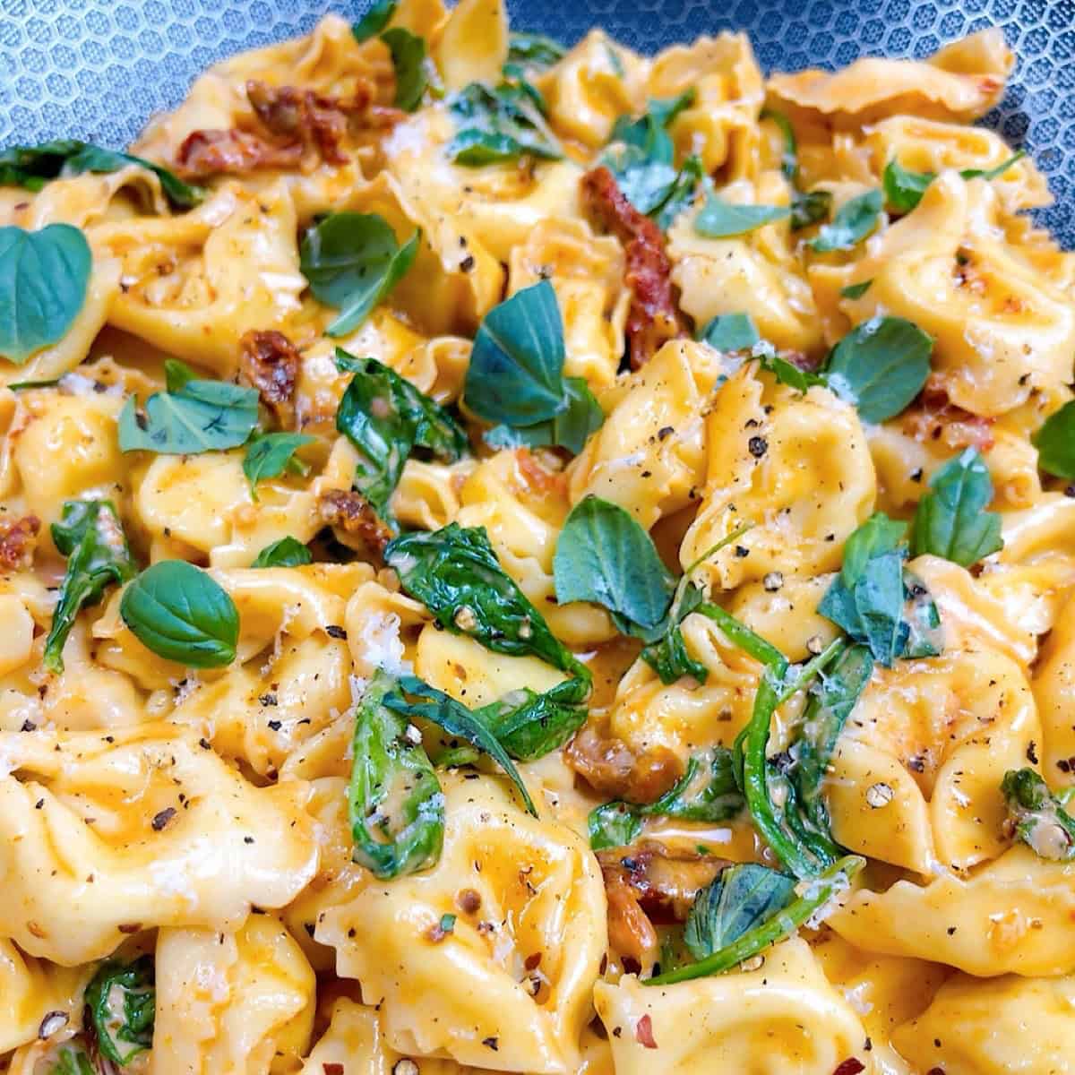 Marry me tortellini prepared in pan with garnish.
