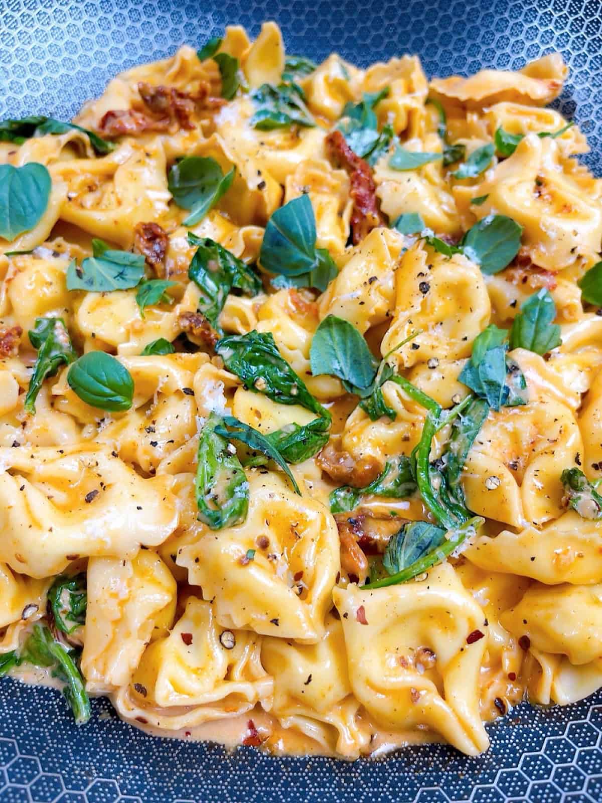Marry me tortellini prepared in pan with garnish.