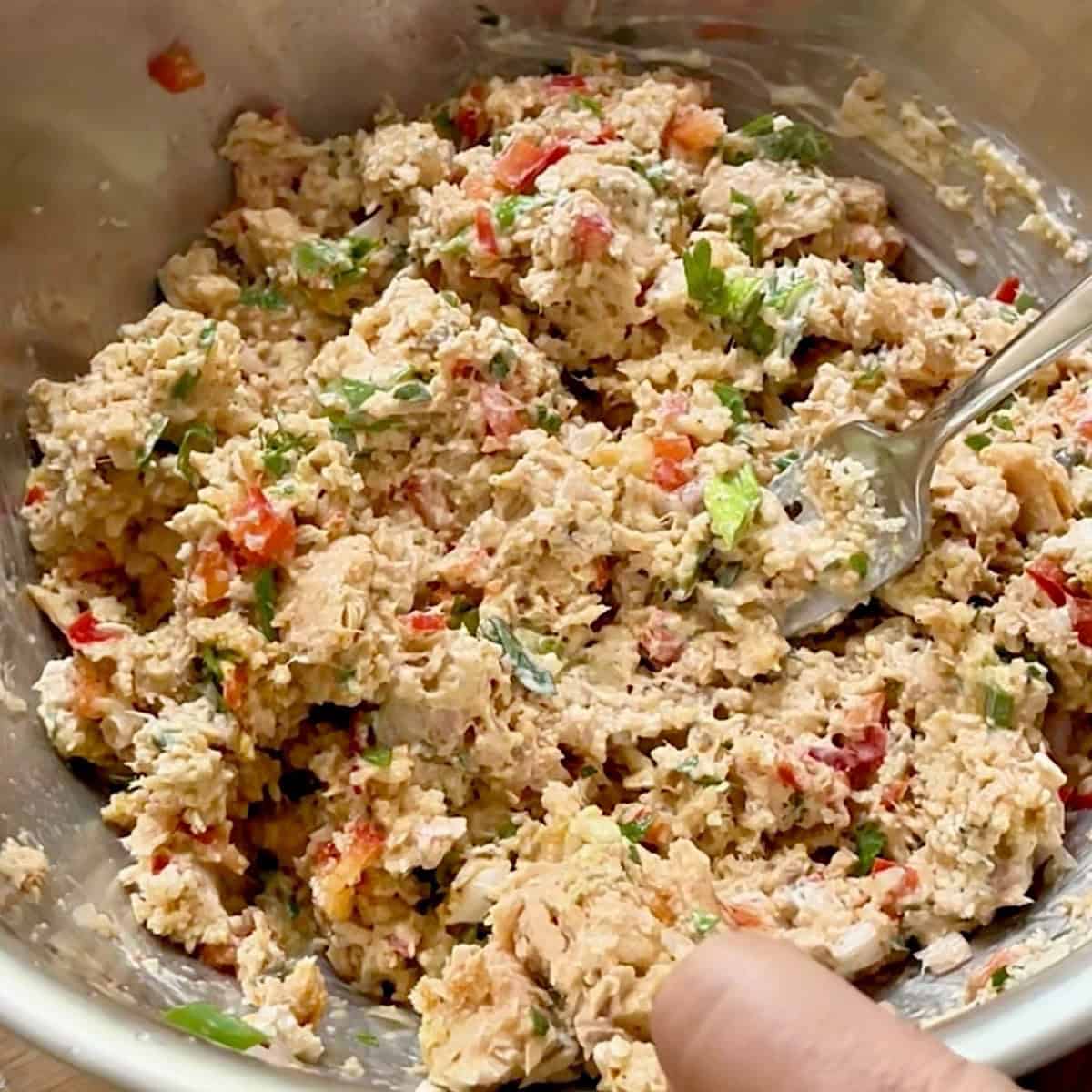 Salmon patty ingredients mixed in a large mixing bowl.