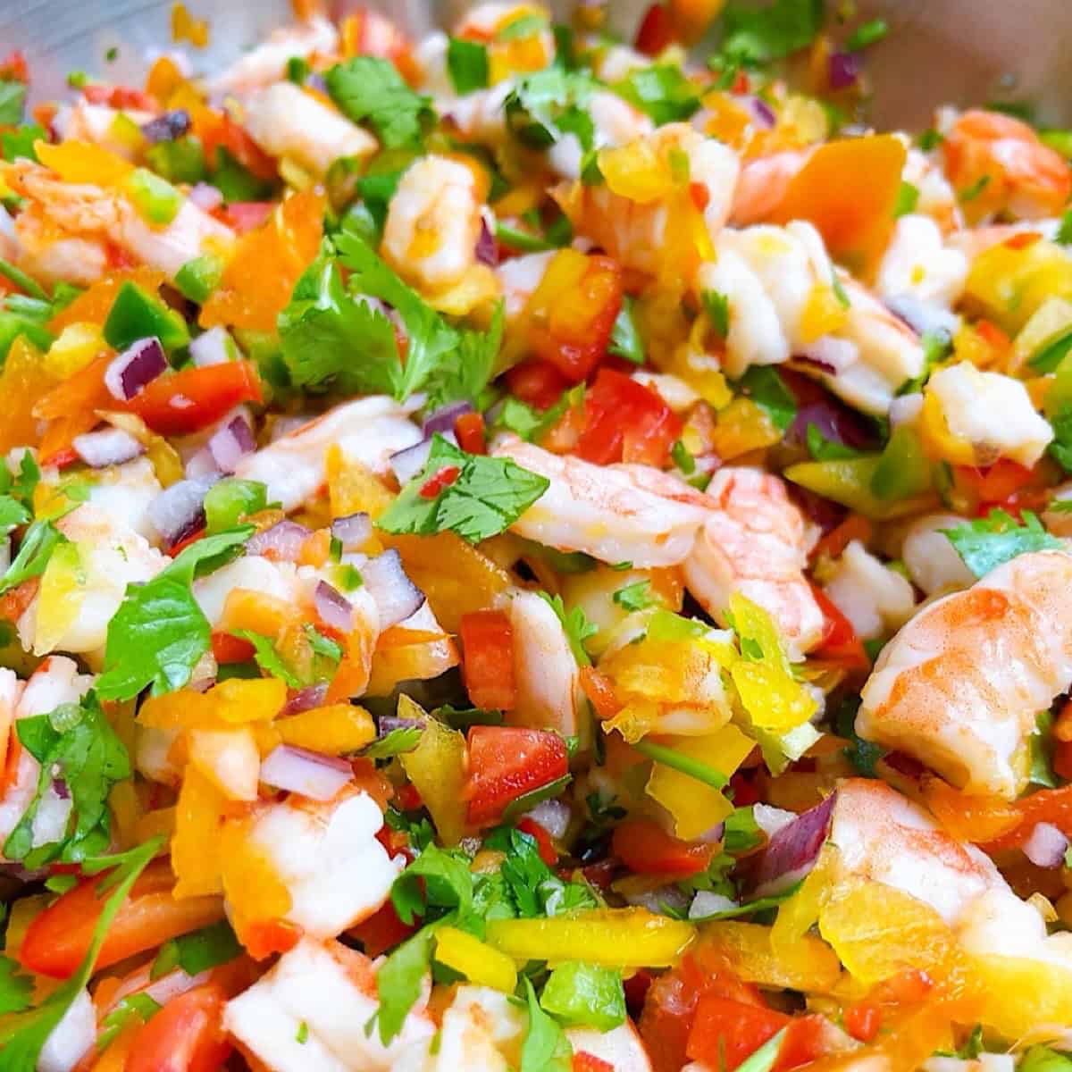 A large bowl of shrimp ceviche with cooked shrimp.